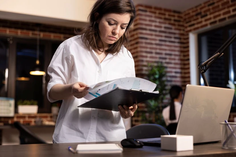 Clinic leader flipping through documents